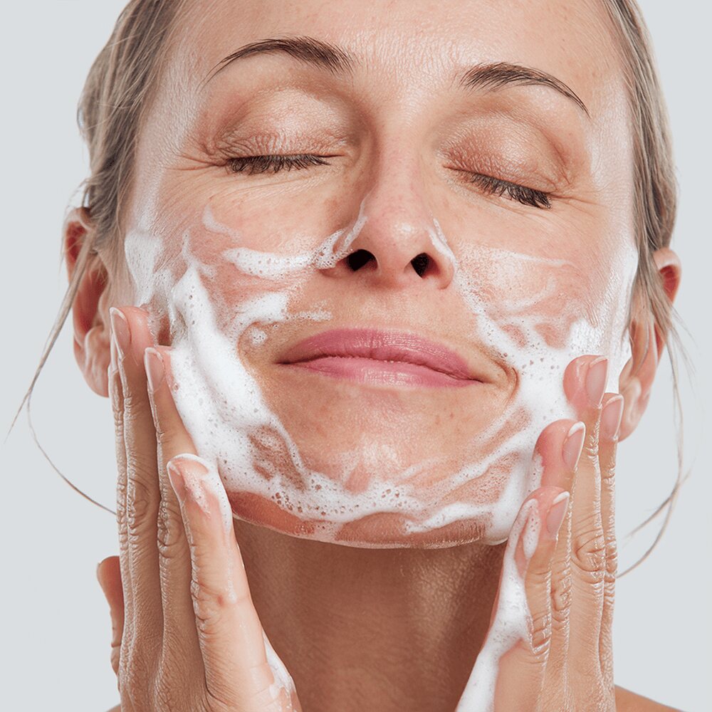 Woman gently cleansing her face